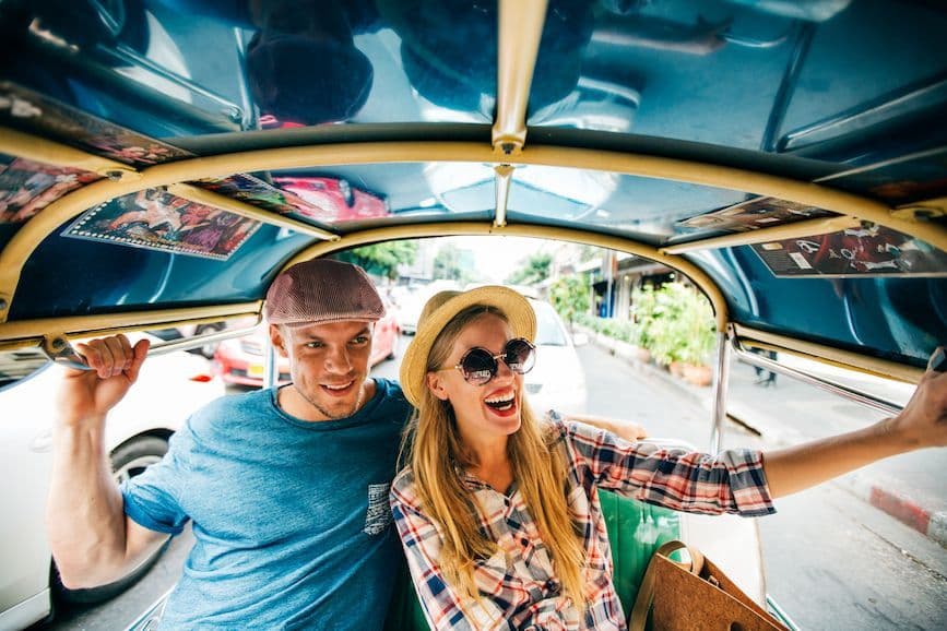 Young couple travelling, back of a vehicle